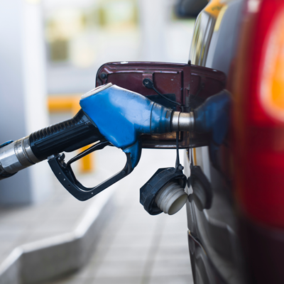 Blue gas inside of gas tank of red car.