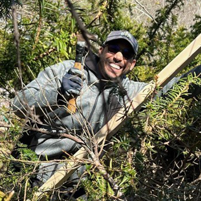Volunteer works with hammer and wood